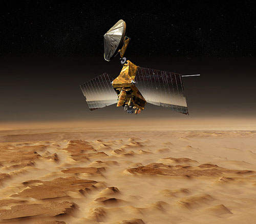 In this image, a graphic representation of the Mars Reconnaissance Orbiter flies over a bumpy martian landscape.  The spacecraft's solar panels are spread open and look like two large billboards.  In between the solar panels is the main, boxy bus of the spacecraft that carries all of the instruments; the most visible of those in this image is large, tube-like HiRISE camera baffle (or cover).  Above the main bus is the large, circular high-gain antenna that allows the spacecraft to communicate with Earth.  Pictured behind the solar panels is the SHARAD antenna, that looks like a long, horizontal rod.