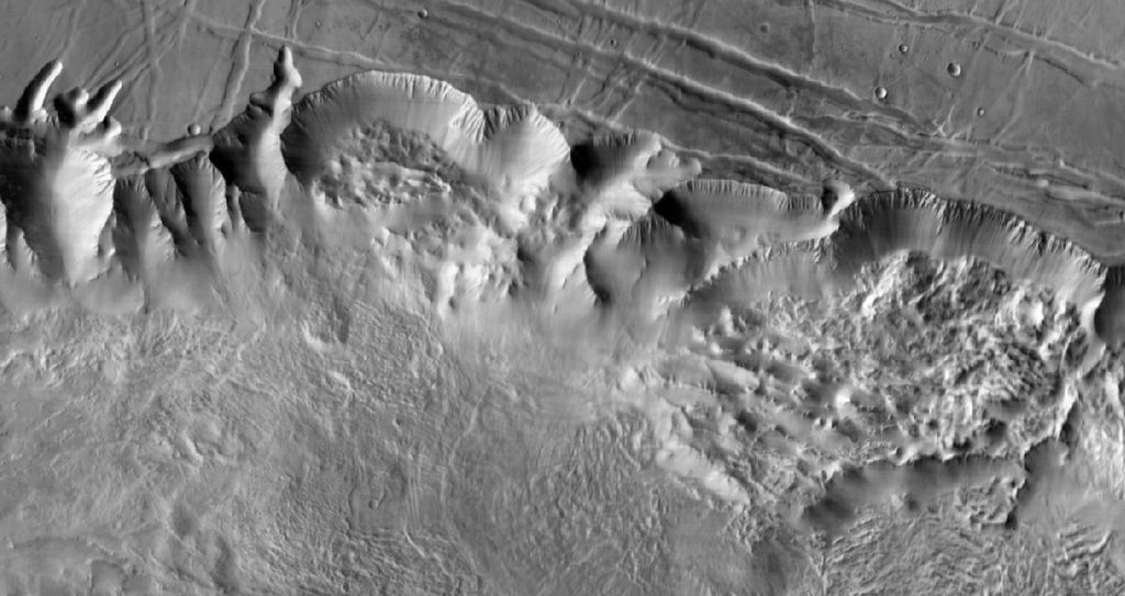 This image shows a 90-mile-wide portion of the giant Valles Marineris canyon system. Landslide debris and gullies in the canyon walls on Mars can be seen at 100 meters (330 feet) per pixel.