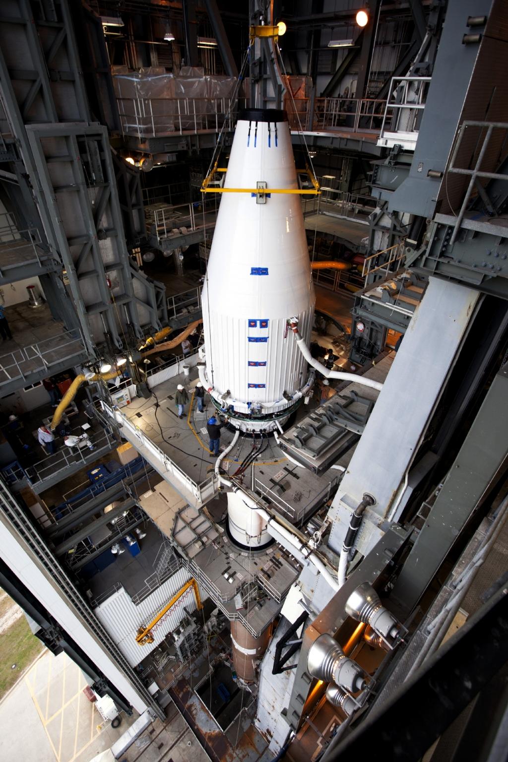 Crews guide NASA's Mars Atmosphere and Volatile EvolutioN, or MAVEN, spacecraft, inside a payload fairing, into place atop a United Launch Alliance Atlas V rocket at the Vertical Integration Facility at Space Launch Complex 41.