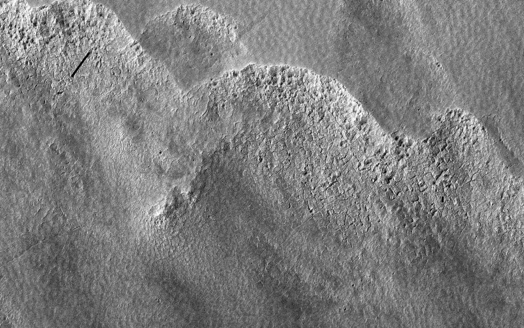 This image is of a portion of the Southern plains region within Hellas, the largest impact basin on Mars, with a diameter of about 2300 kilometers (1400 miles).