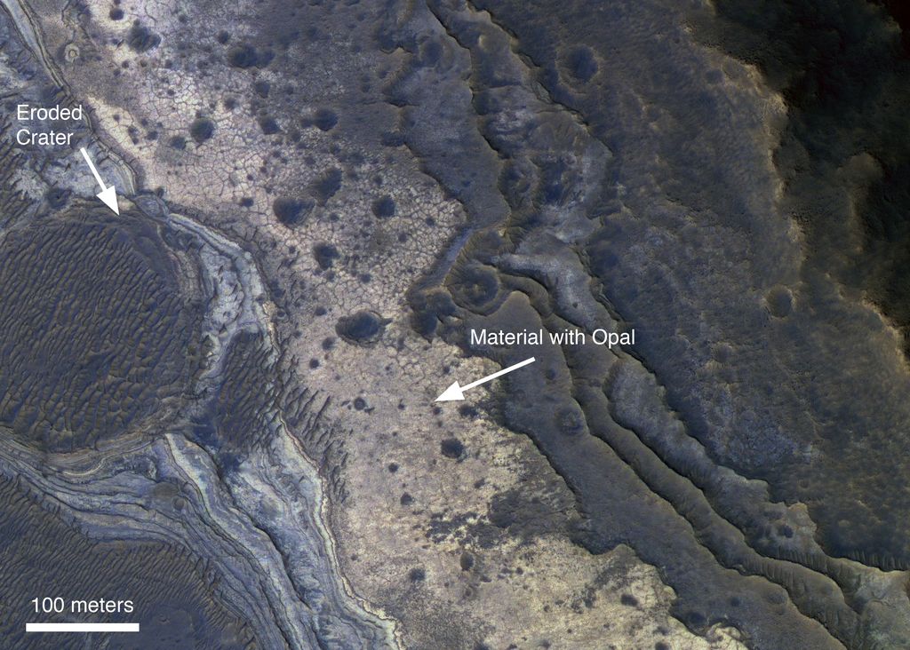 NASA's Mars Reconnaissance Orbiter has revealed Martian rocks containing a hydrated mineral similar to opal. The rocks are light-toned and appear cream-colored in this false-color image taken by the High Resolution Imaging Science Experiment camera. Images acquired by the orbiter reveal that different layers of rock have different properties and chemistry. The opal minerals are located in distinct beds of rock outside of the large Valles Marineris canyon system and are also found in rocks within the canyon. The presence of opal in these relatively young rocks tells scientists that water, possibly as rivers and small ponds, interacted with the surface as recently as two billion years ago, one billion years later than scientists had expected. The discovery of this new category of minerals spread across large regions of Mars suggests that liquid water played an important role in shaping the planet's surface and possibly hosting life.