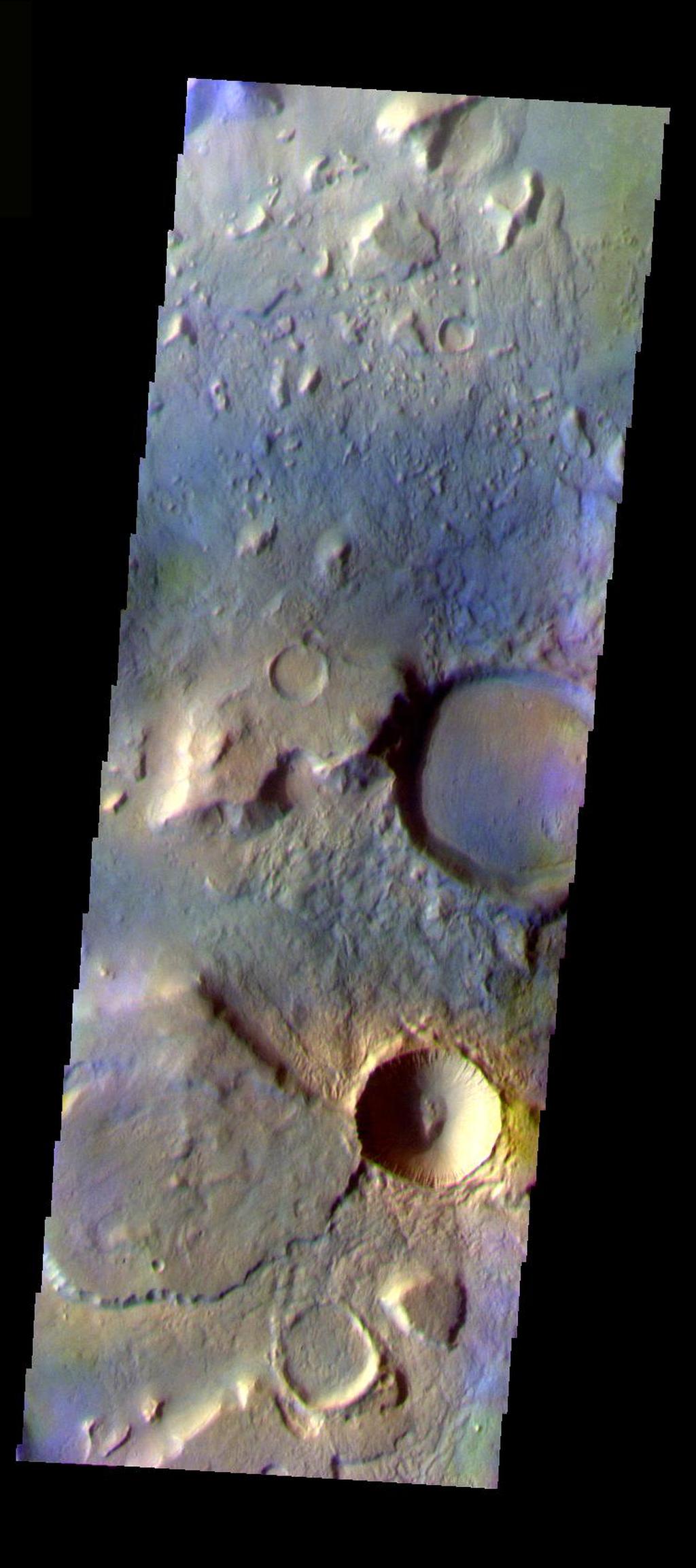 This false color image shows a region with craters of different ages located at the margin of Acidalia Planitia. This image was collected during the Northern Spring season. The THEMIS VIS camera is capable of capturing color images of the Martian surface using five different color filters. In this mode of operation, the spatial resolution and coverage of the image must be reduced to accommodate the additional data volume produced from using multiple filters. To make a color image, three of the five filter images (each in grayscale) are selected. Each is contrast enhanced and then converted to a red, green, or blue intensity image. These three images are then combined to produce a full color, single image. Because the THEMIS color filters don't span the full range of colors seen by the human eye, a color THEMIS image does not represent true color. Also, because each single-filter image is contrast enhanced before inclusion in the three-color image, the apparent color variation of the scene is exaggerated. Nevertheless, the color variation that does appear is representative of some change in color, however subtle, in the actual scene. Note that the long edges of THEMIS color images typically contain color artifacts that do not represent surface variation.