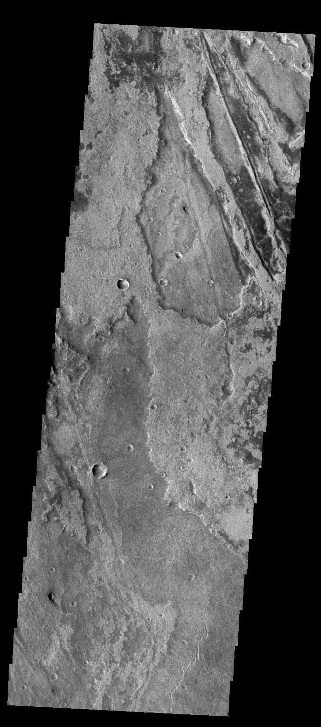 Just as on Earth, volcanism and tectonism are found together on Mars. Here is an example: the ridges and fractures of Claritas Fossae are affecting or perhaps hosting the volcanic flows of Solis Planum.