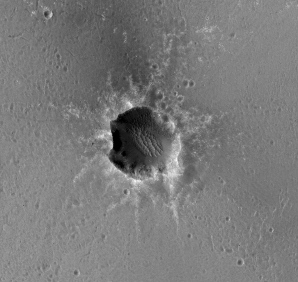 The High Resolution Imaging Science Experiment (HiRISE) camera on NASA's Mars Reconnaissance Orbiter acquired this image of the Opportunity rover on the southwest rim of "Santa Maria" crater on New Year's Eve 2010, or Martian day (sol) 2466 of the rover's work on Mars.