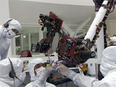 This video clip shows engineers in the JPL clean room giving the rover lessons in hand-eye coordination.