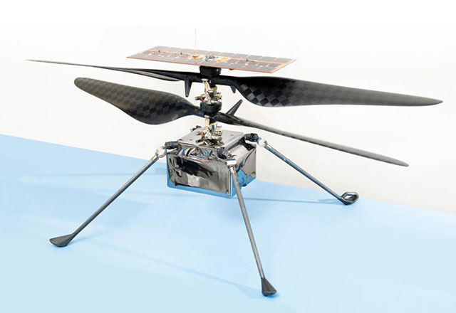 The Mars Helicopter features two pairs of counter-rotating blades, over a small fuselage box with four thin, outstretched legs.